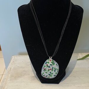 Handcrafted from an eyeglass lens and hangs on an adjustable 19” cord